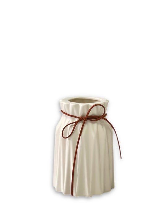 Porcelain white matte vase with brown ribbon